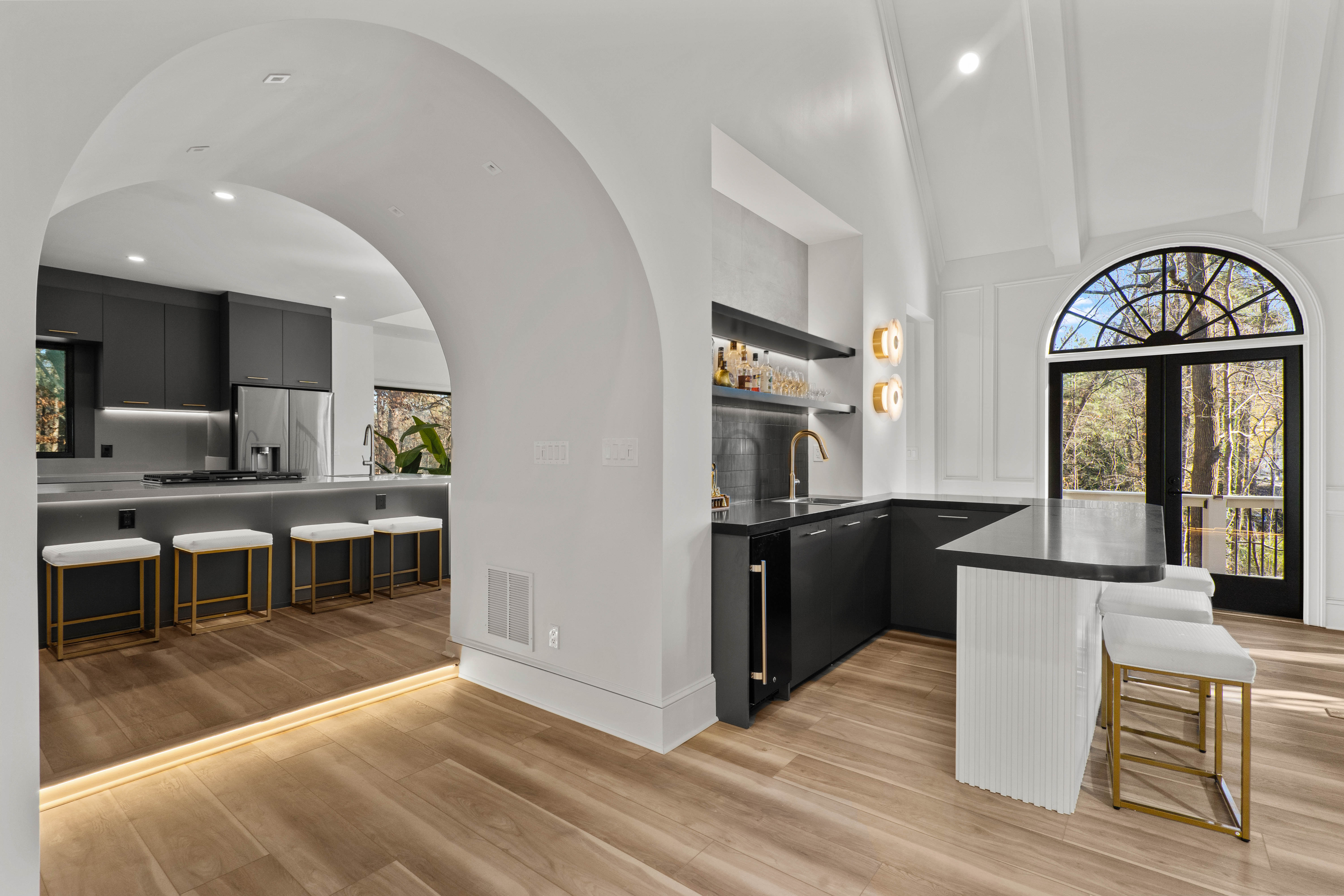 Wet bar after — arched entry with black stone