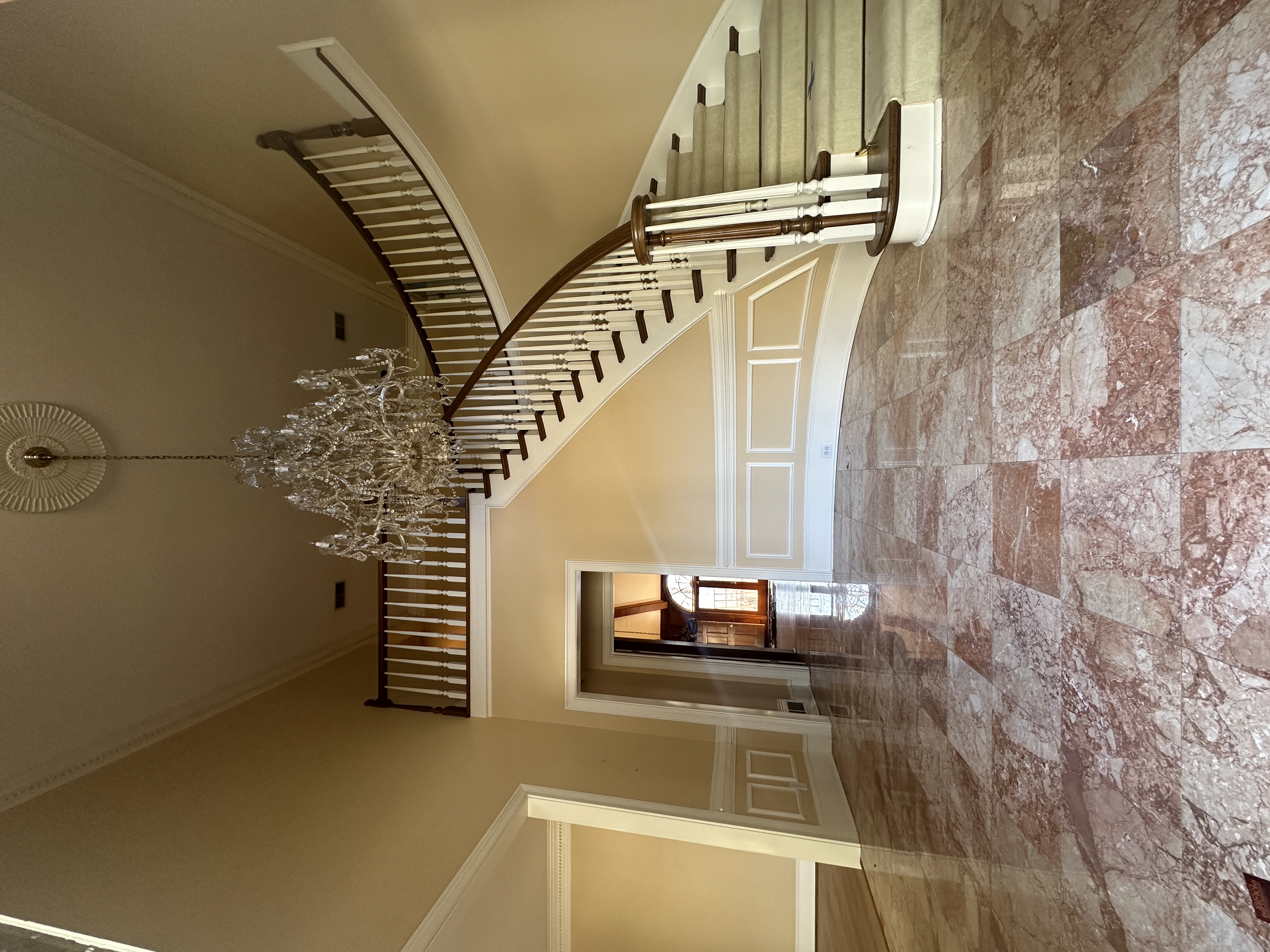 Foyer before — dated finishes