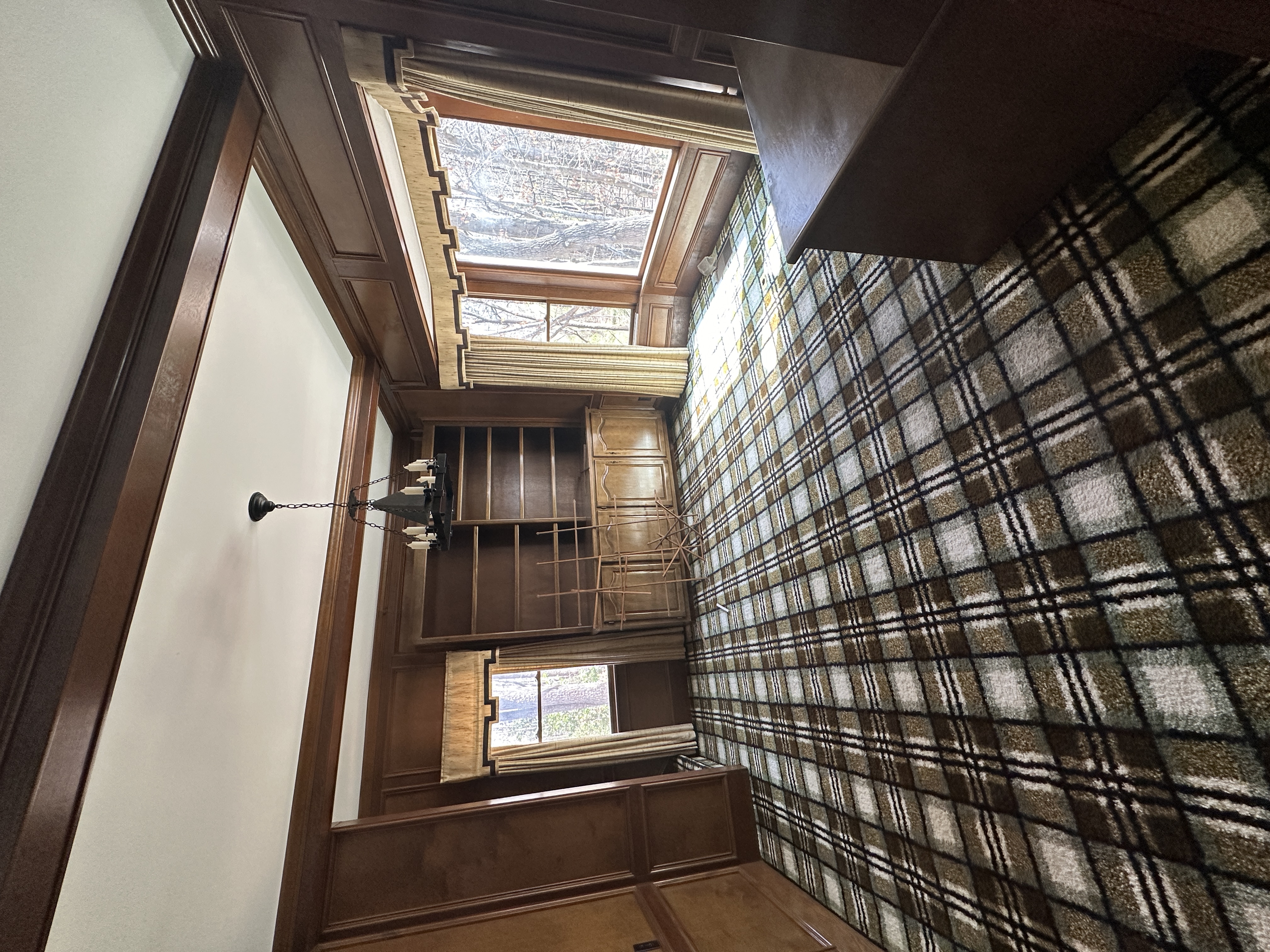 Stairway before — plaid carpet, dark wood