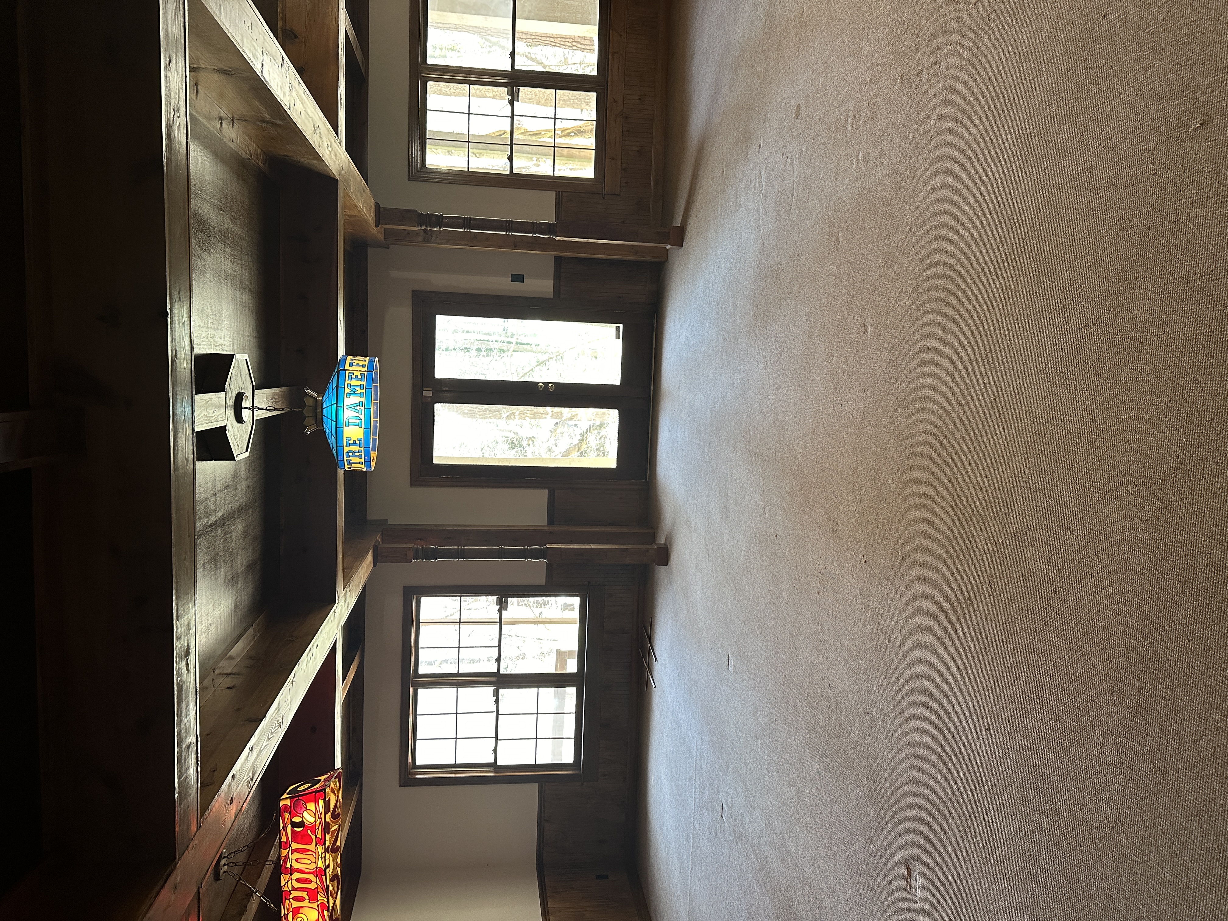 Room before — exposed beams, rustic wood walls