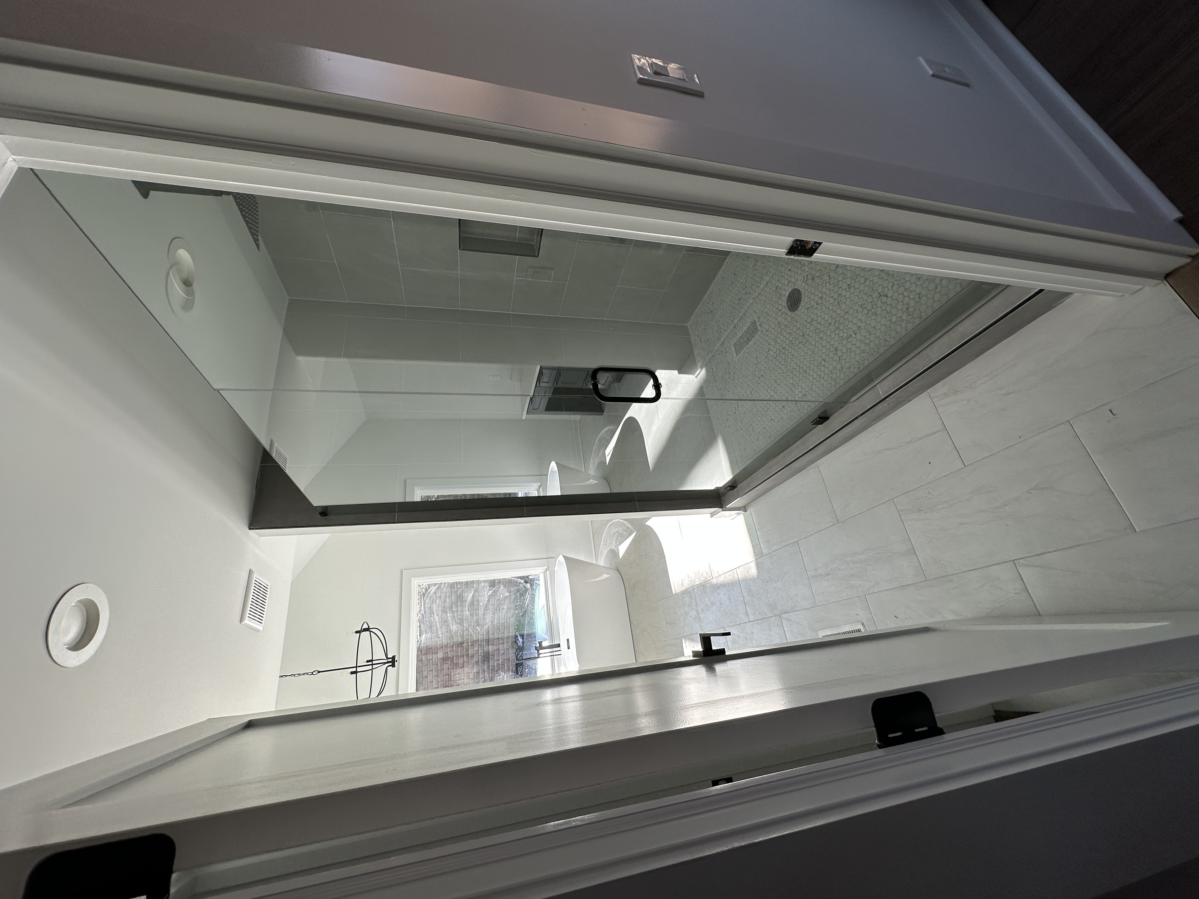 Primary bathroom — glass shower and freestanding tub