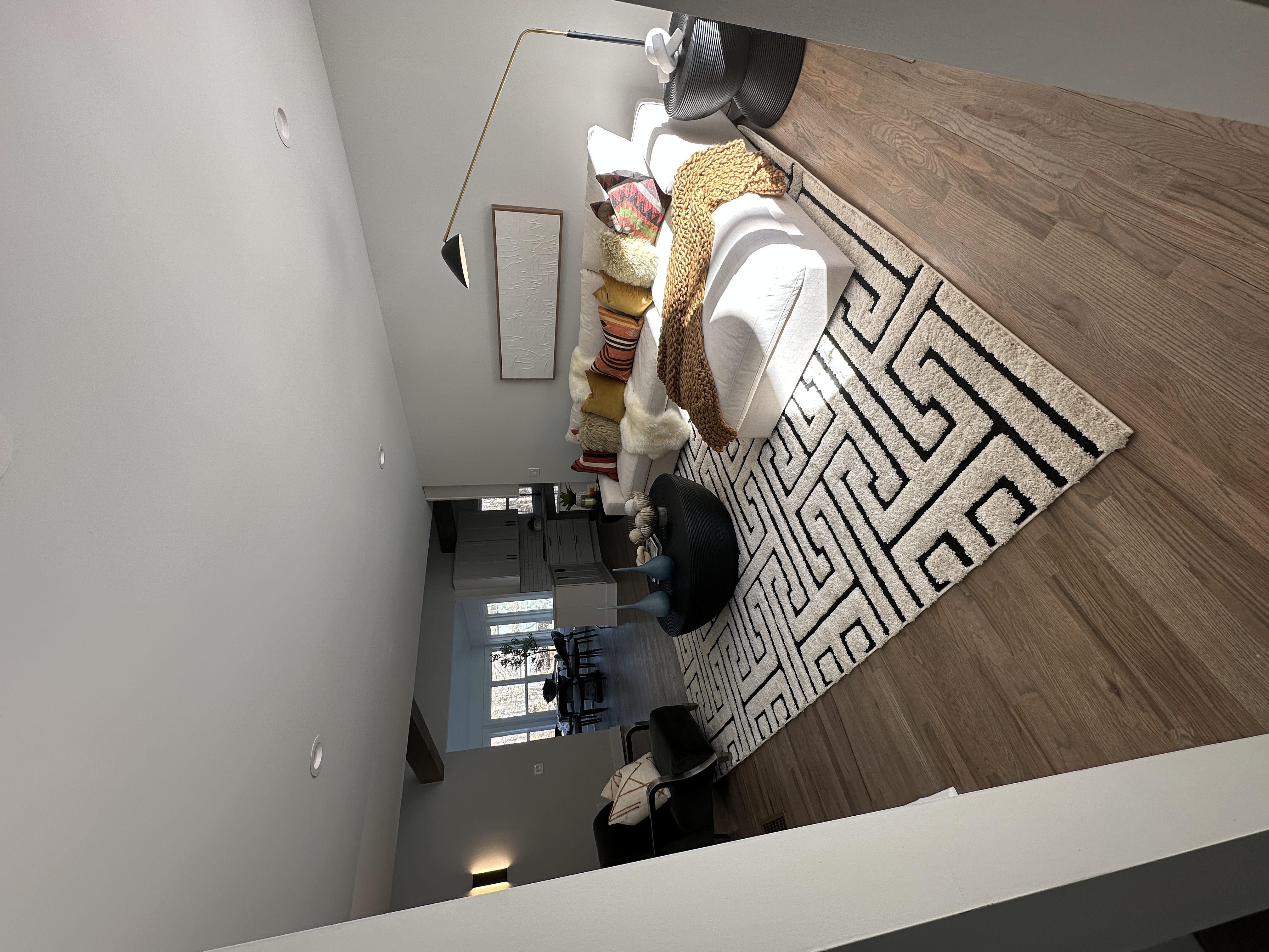 Staged living room — sectional, geometric rug