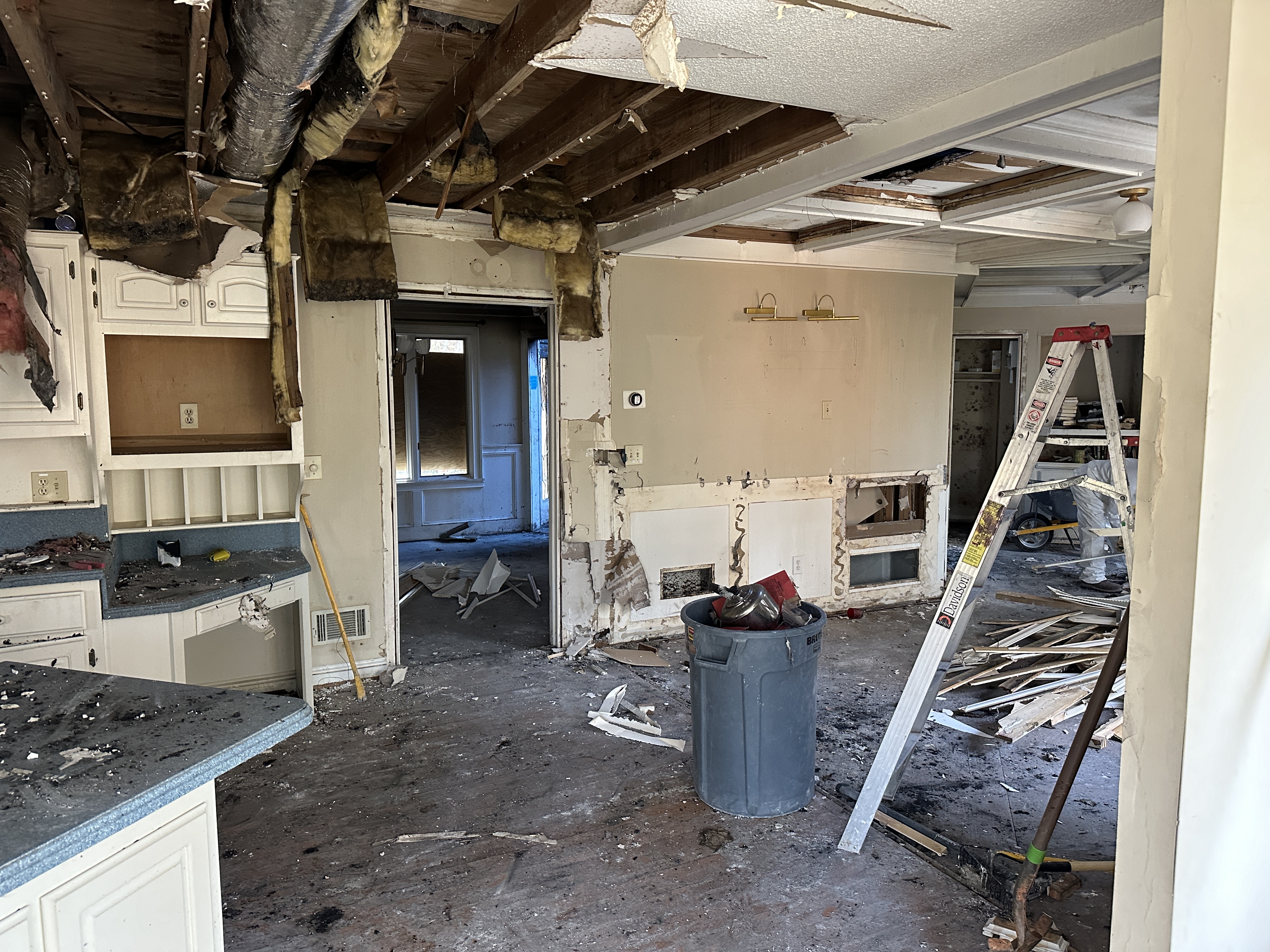 Fire-damaged kitchen — gutted, water damage