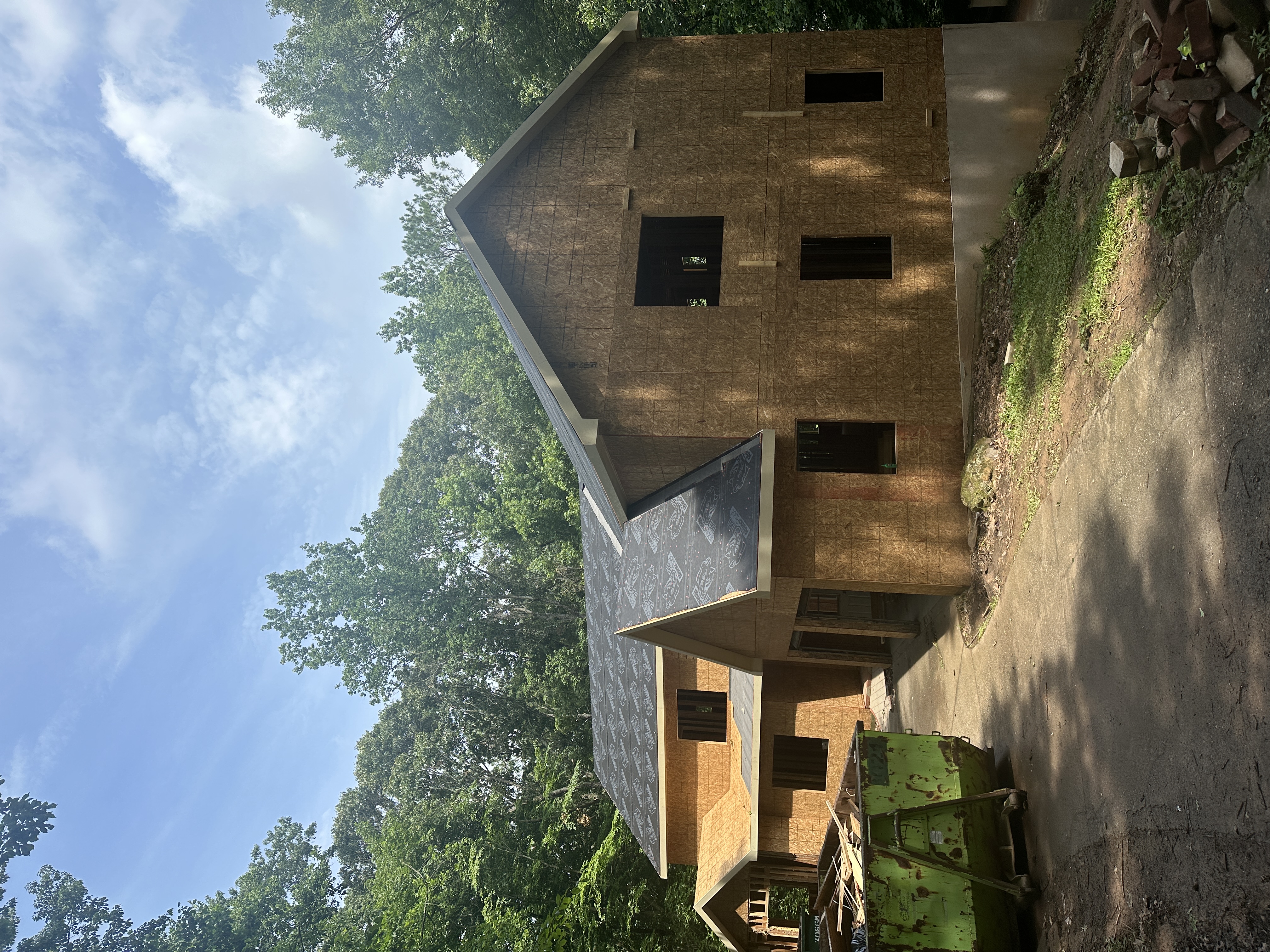 Front exterior before — framing and sheathing